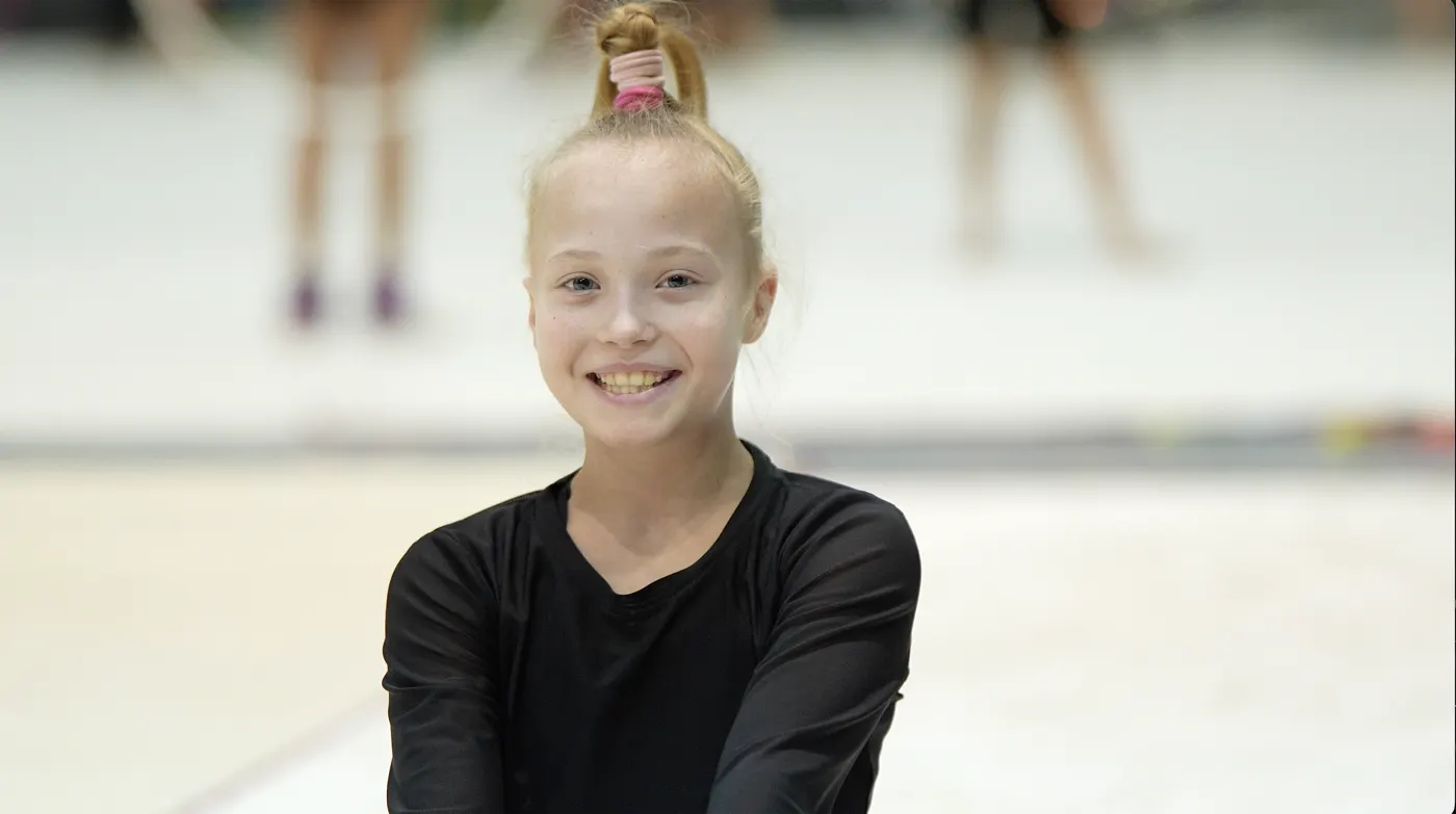 A gymnast smiling during training